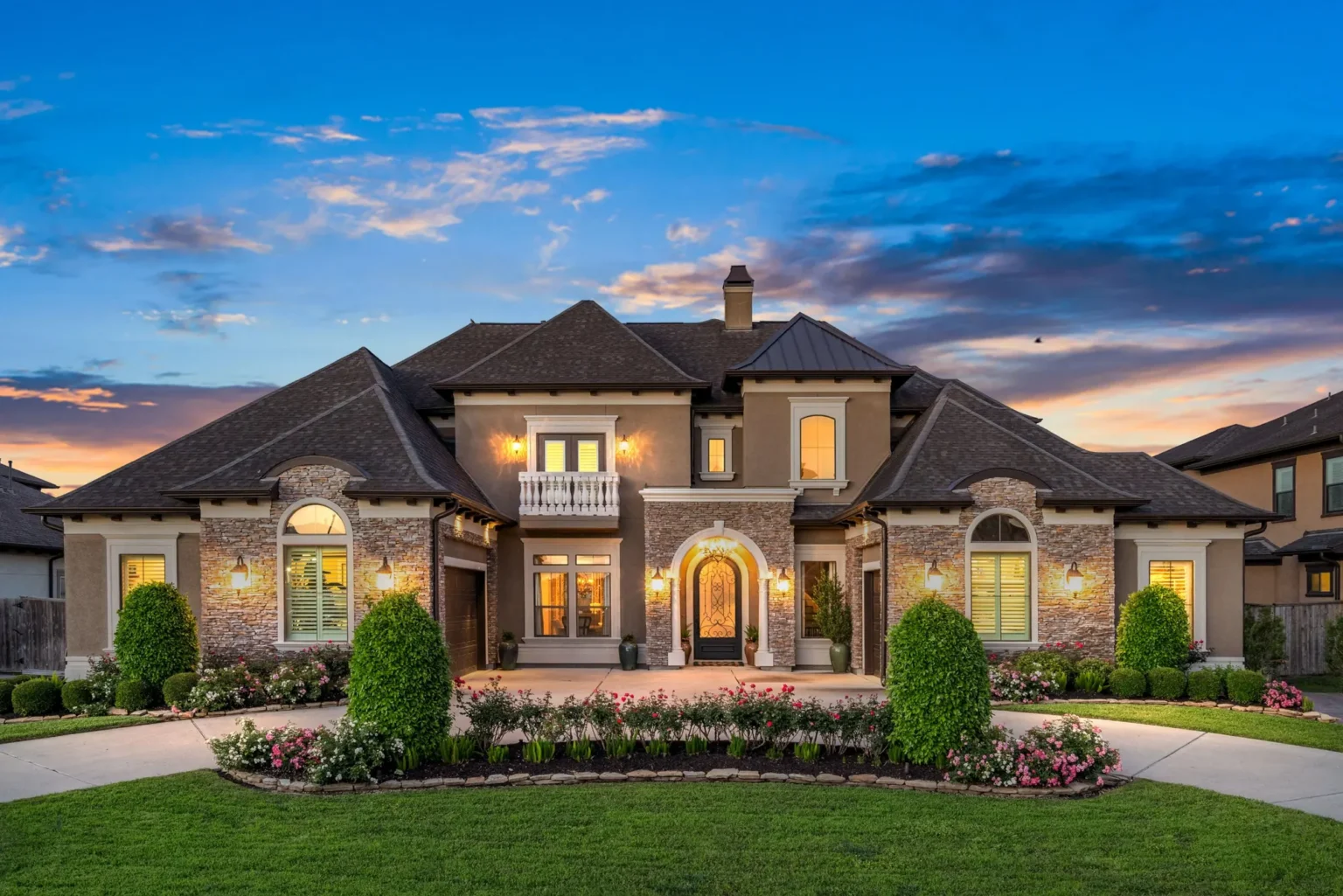 Luxury stone and stucco home at twilight