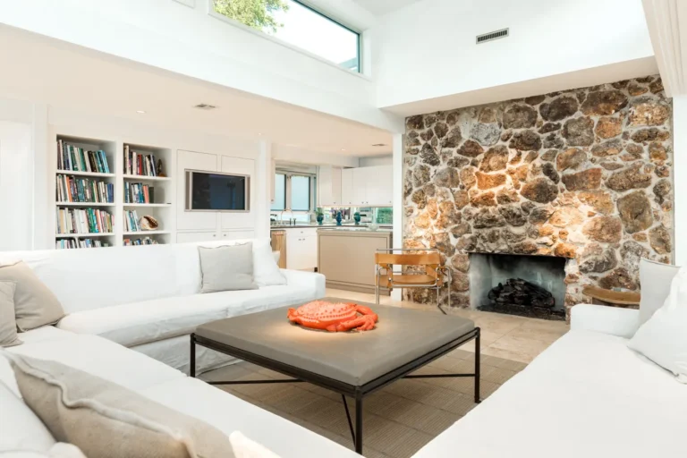 Living room with stone fireplace in a waterfront home on the Texas Gulf Coast